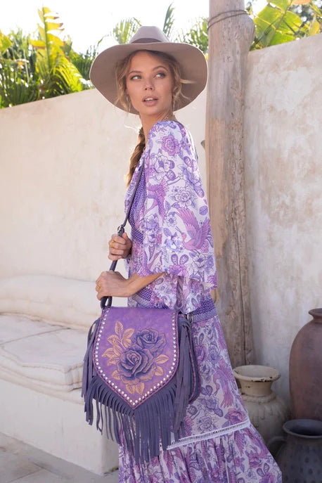 Model wearing the Akaroa Rose Hand Painted Leather Shoulder Bag, Style No. ADBG702A – luxury artisan western handbag styled for Rodeo Trends