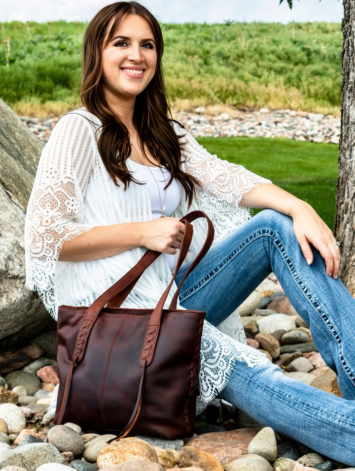 Woman carrying Reagan concealed carry tote in Cognac leather by Lady Conceal