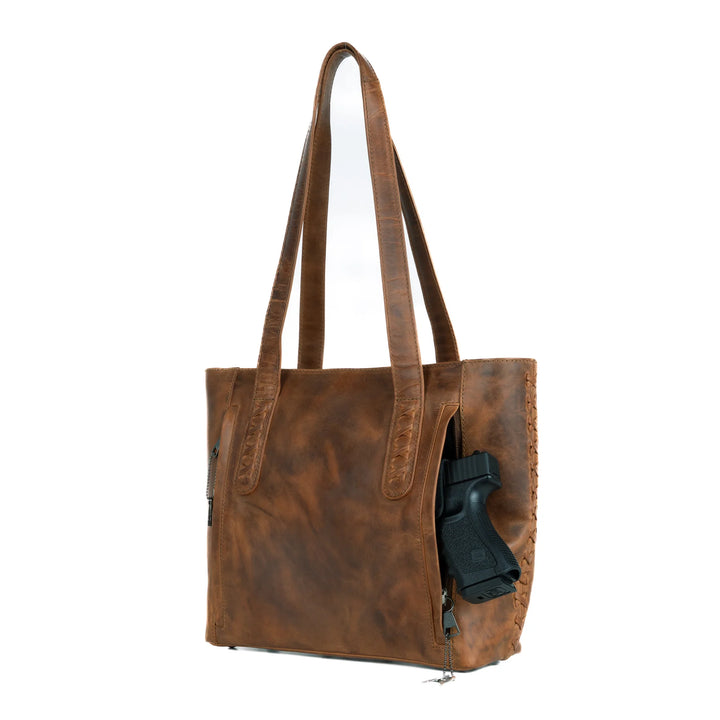 Side view of Reagan medium tote in Cognac leather with slim profile