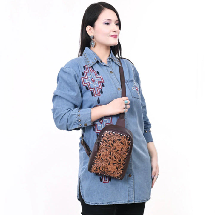 Model wearing American Darling ADBGA661 sling bag with Western fringe and floral tooling – Rodeo Trends collection.