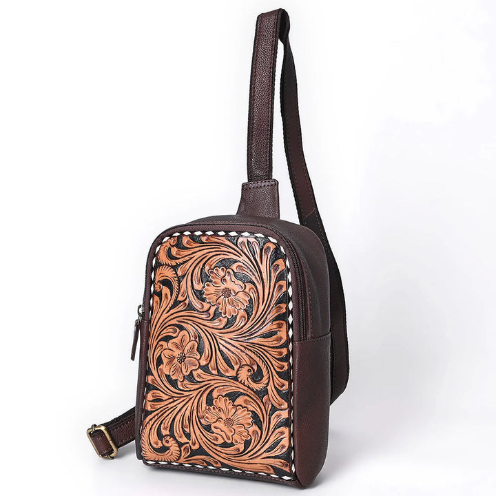 Side profile of hand-tooled brown leather sling bag with adjustable strap – handcrafted by American Darling.