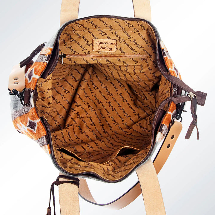 Interior view of American Darling tote bag with zippered pockets, soft lining, and organizational compartments.