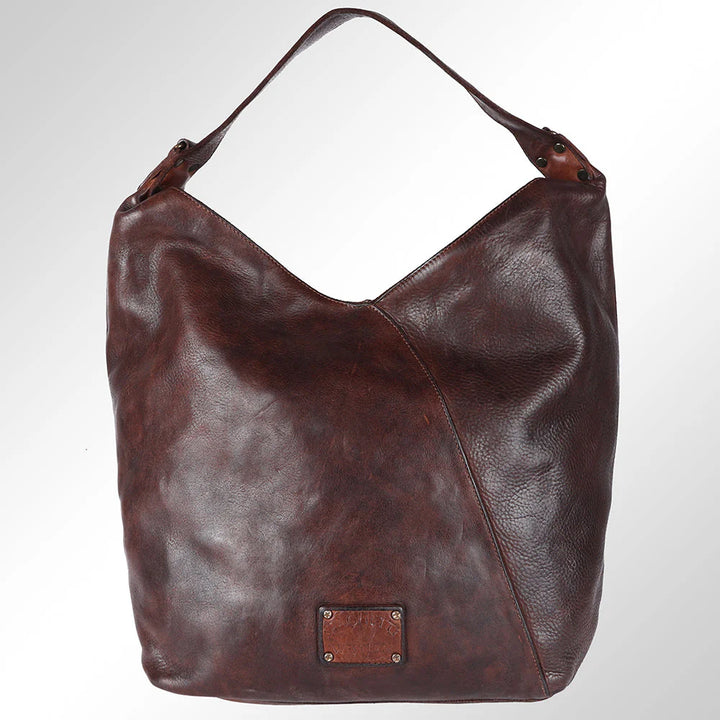 Back of Spaghetti Western brown leather bag showing smooth finish and full-grain leather texture.